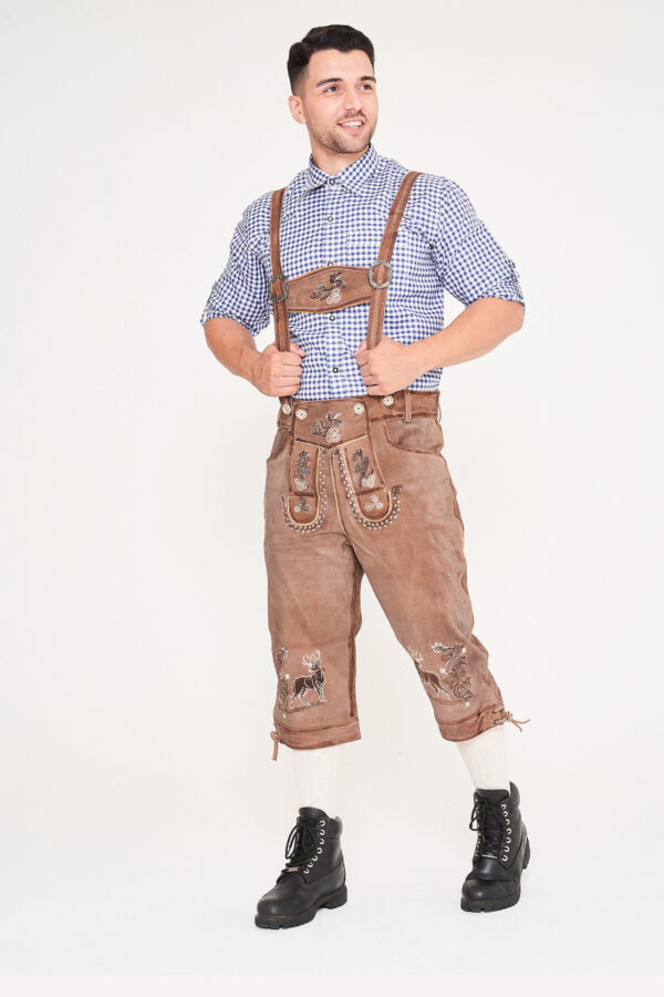 Man posing sideways in knee-length shaded brown Bundhosen Lederhosen. - Lederhosen For Sale