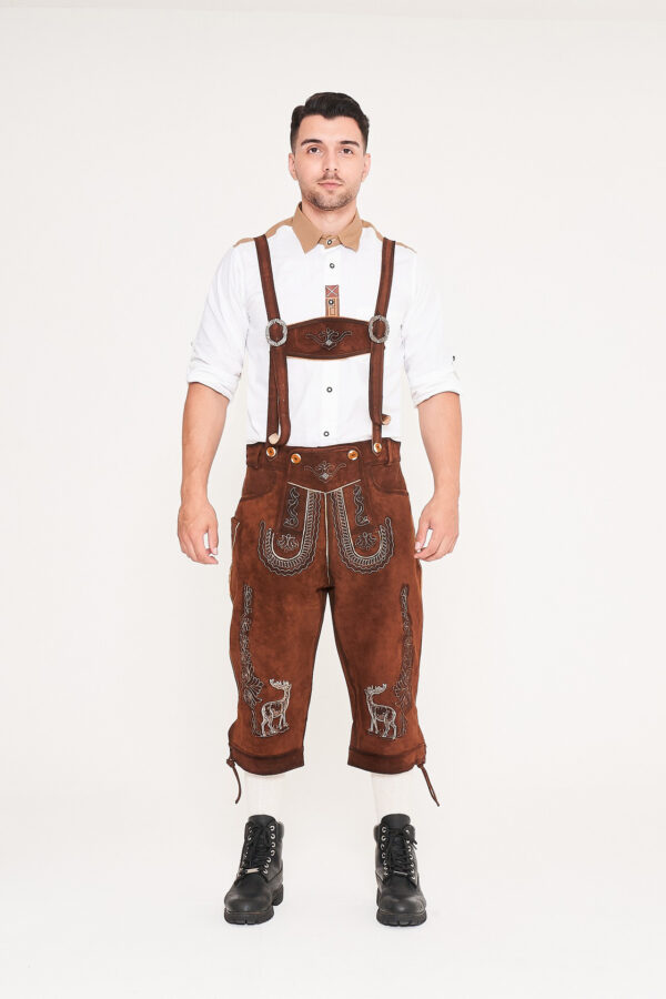 Man standing in knee-length brown deer motif Lederhosen. - Lederhosen For Sale