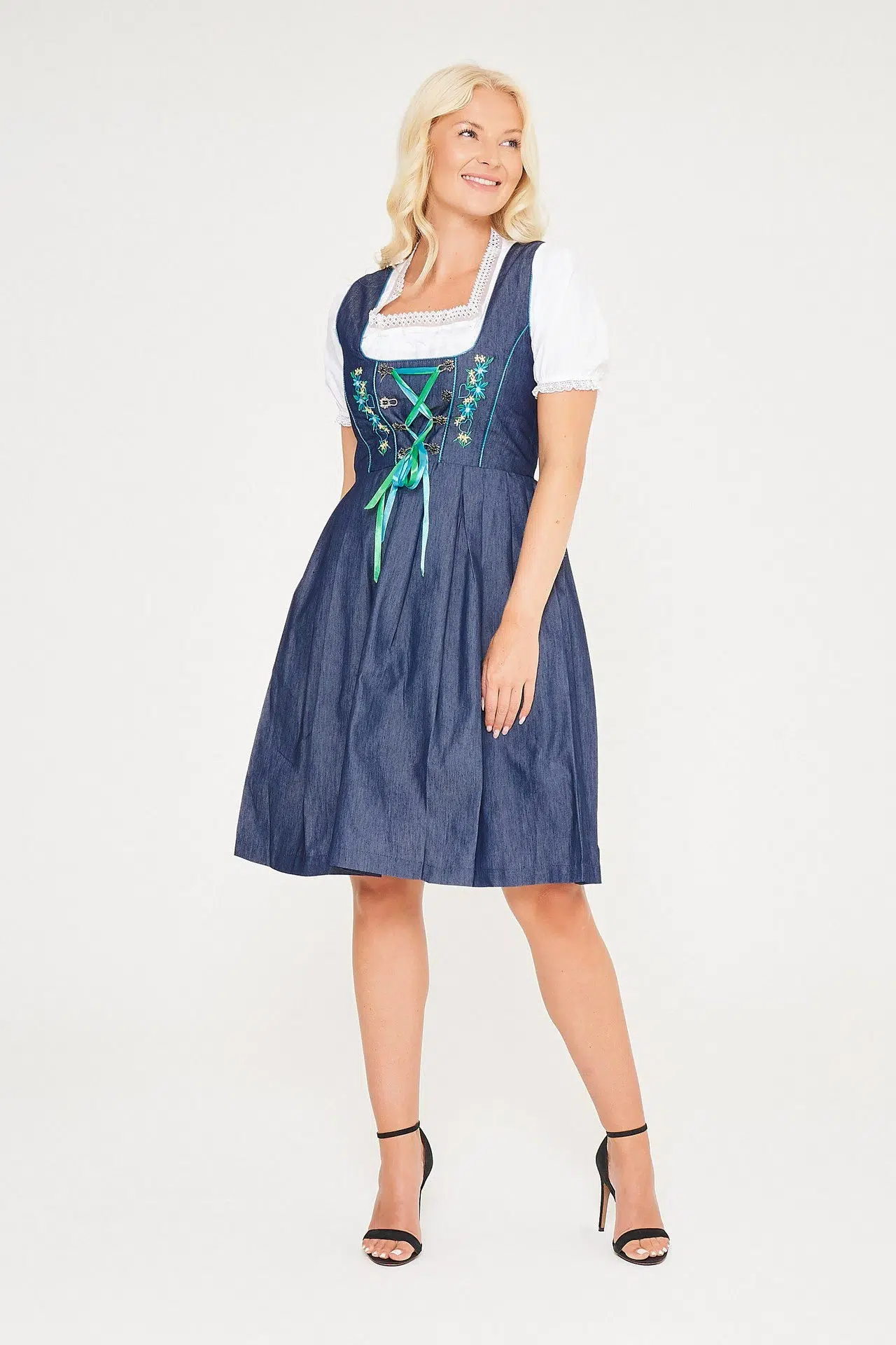 Blonde woman posing in blue denim Erna midi Dirndl. - Lederhosen For Sale