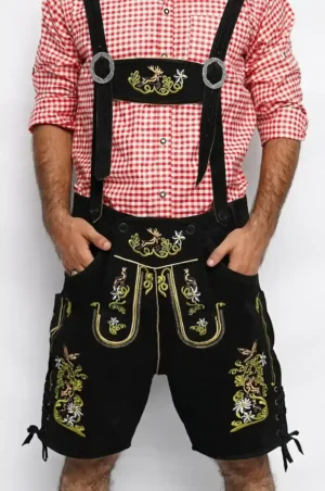 Front view of men's black Lederhosen with vibrant stag and floral embroidery paired with a red checkered shirt. - Lederhosen For Sale