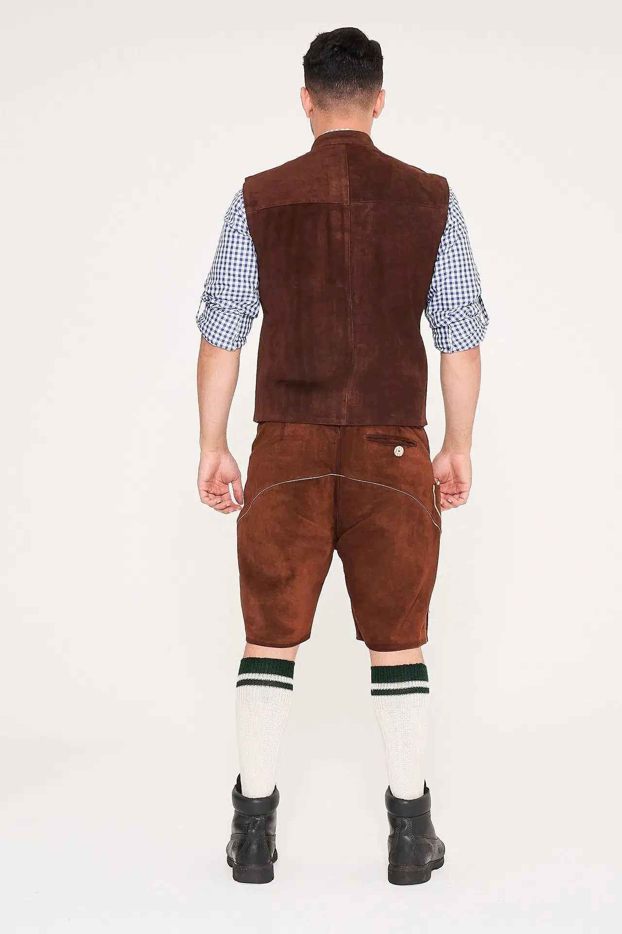 Rear view of man in brown suede waistcoat, Lederhosen, and blue checkered shirt. - Lederhosen For Sale