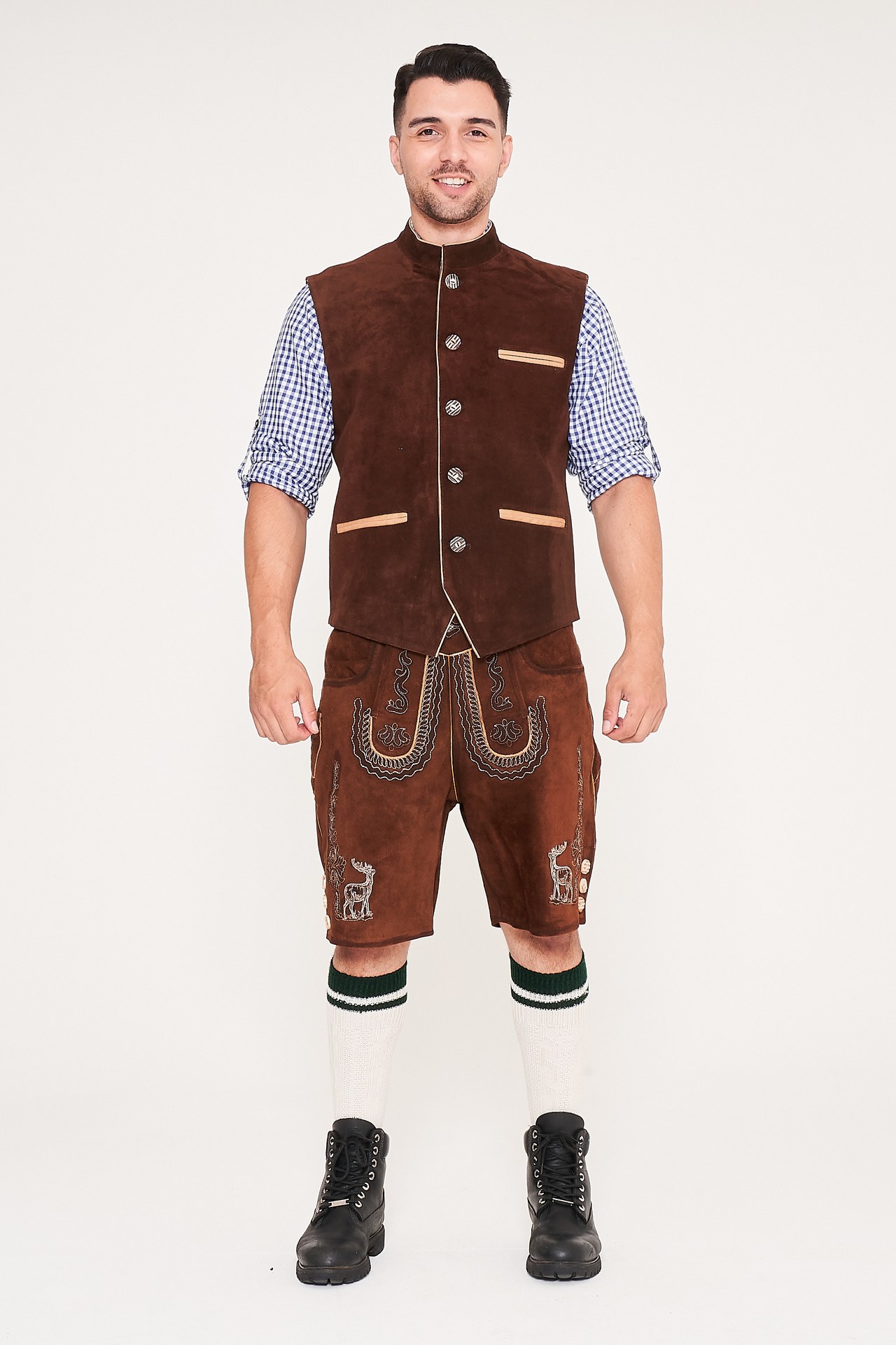 Front view of man standing in brown waistcoat, Lederhosen, and blue checkered shirt. - Lederhosen For Sale