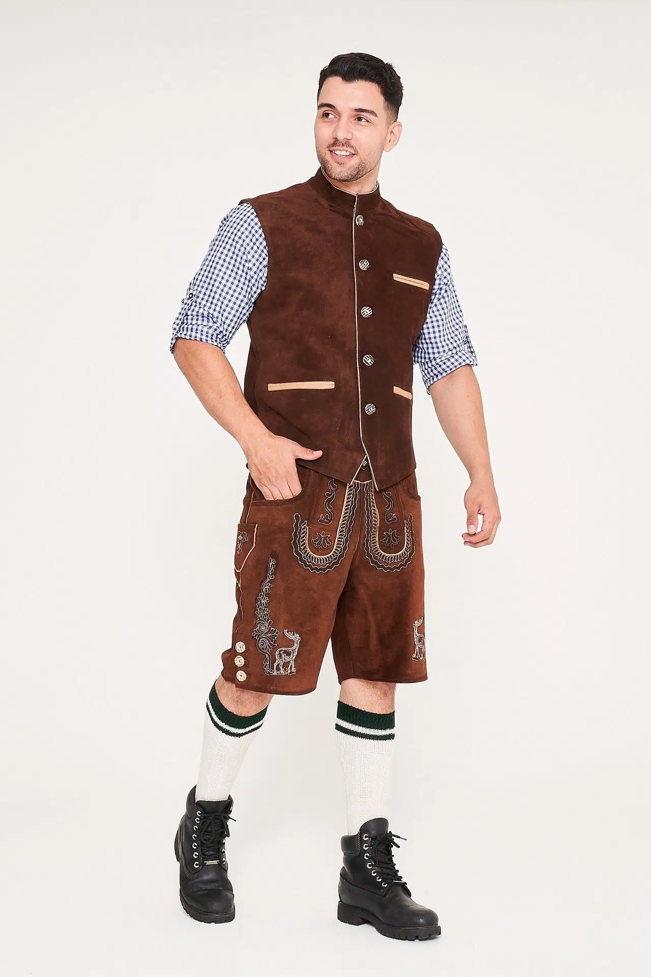 Front view of man walking in brown waistcoat, Lederhosen, and blue checkered shirt. - Lederhosen For Sale