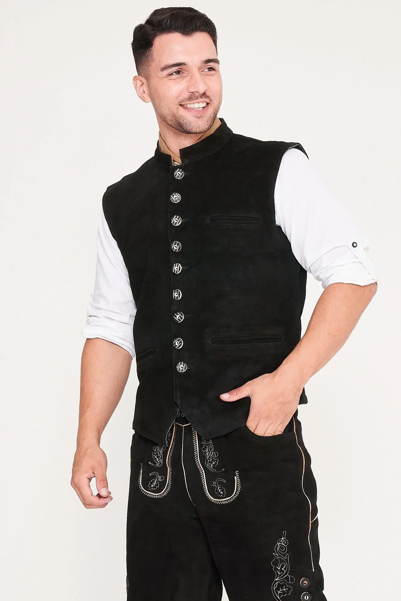 Front view of man walking in black waistcoat, Lederhosen, and white shirt. - Lederhosen For Sale