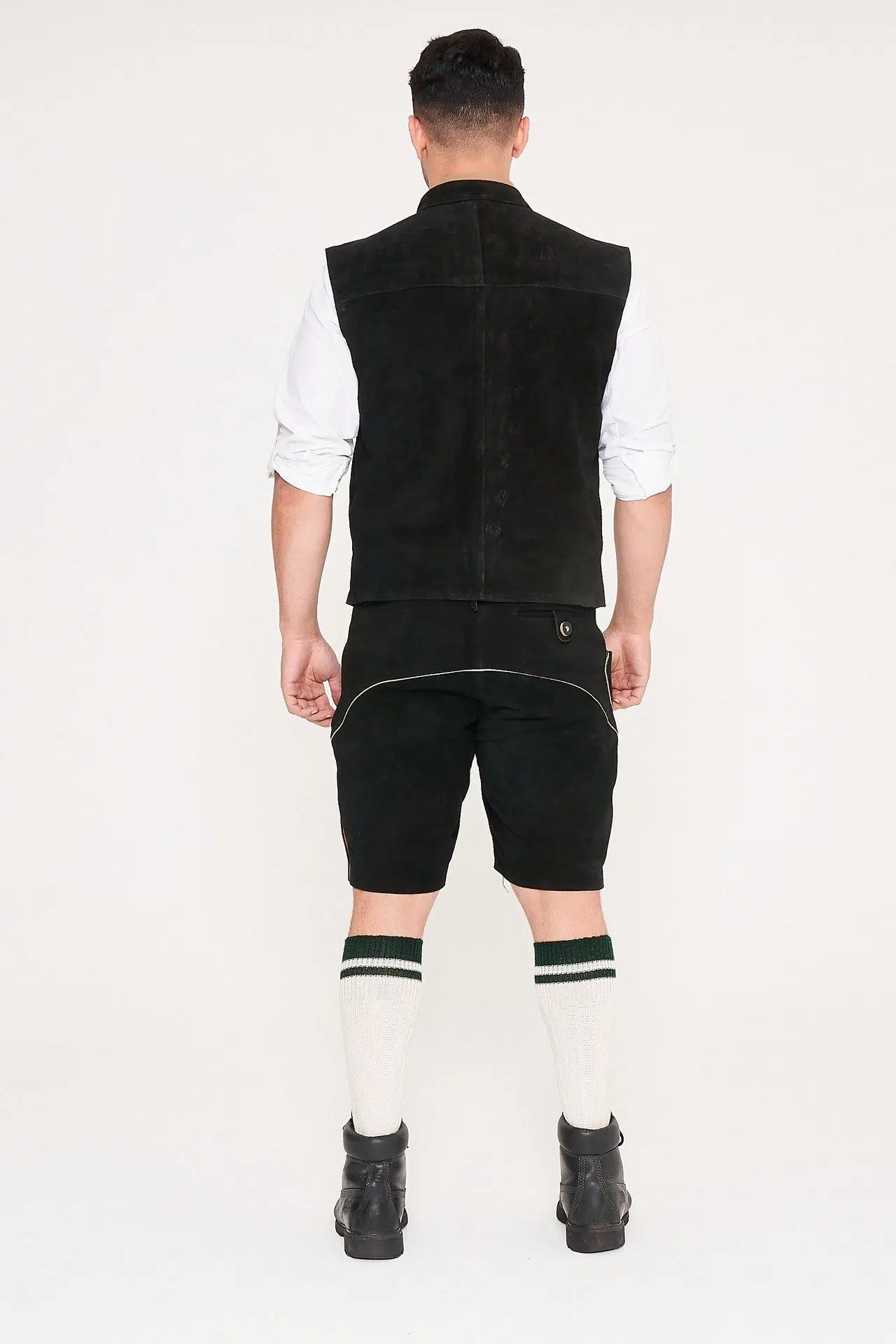 Rear view of man in black waistcoat, Lederhosen, and white shirt. - Lederhosen For Sale