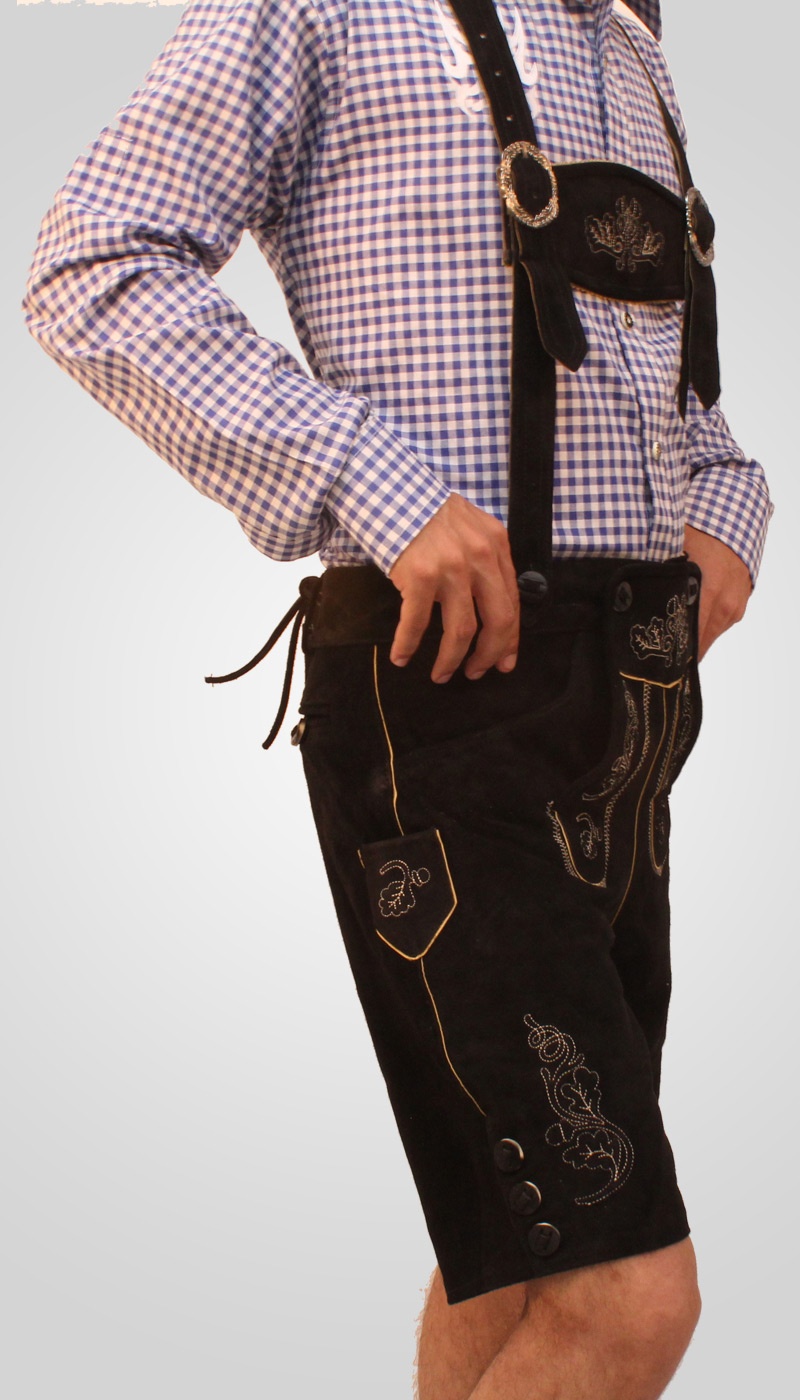 Side view of man in black embroidered Lederhosen. - Lederhosen For Sale
